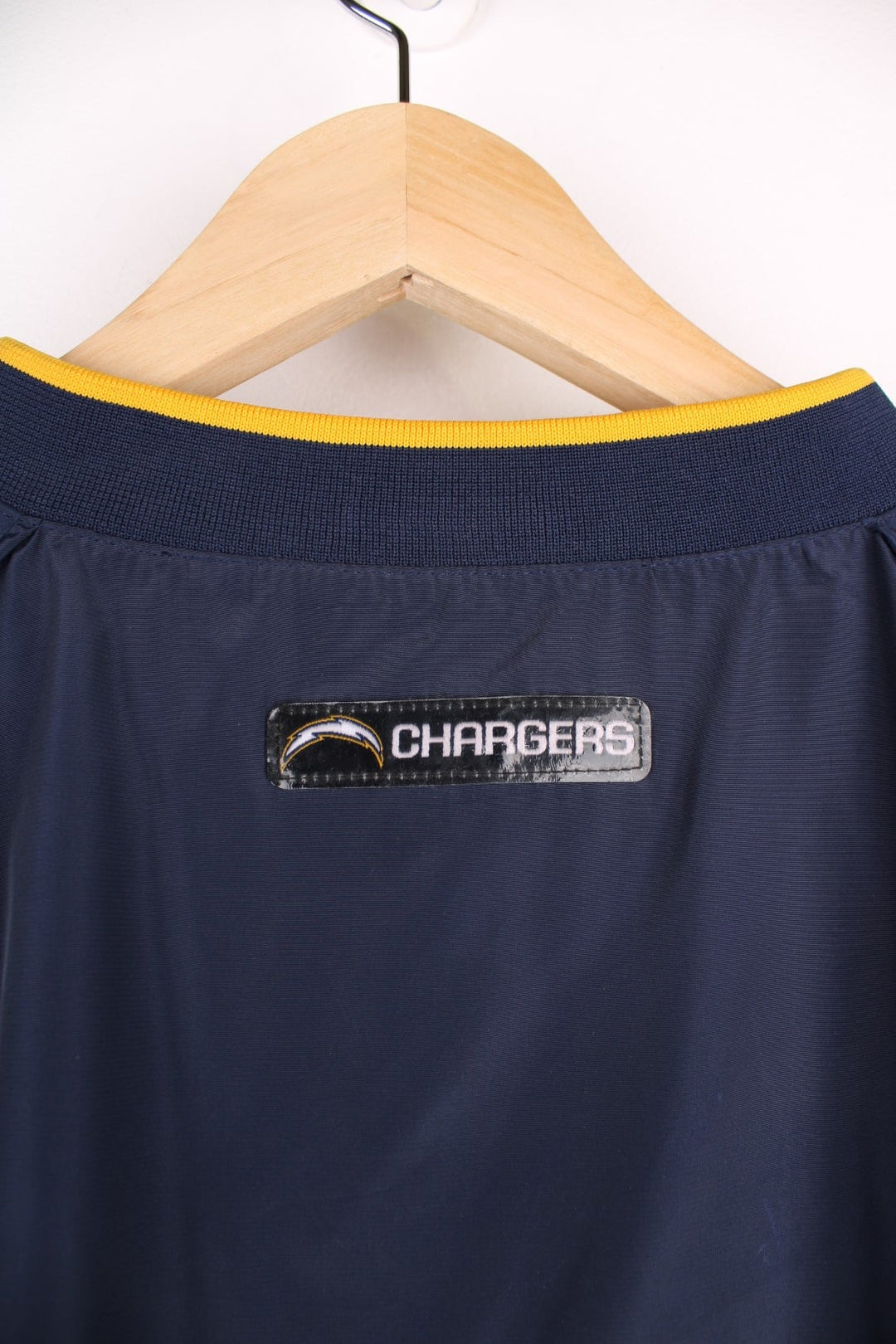 Chargers NFL drill top in a navy colourway with yellow side panels. Chargers logo on front and back and NFL logo on front.