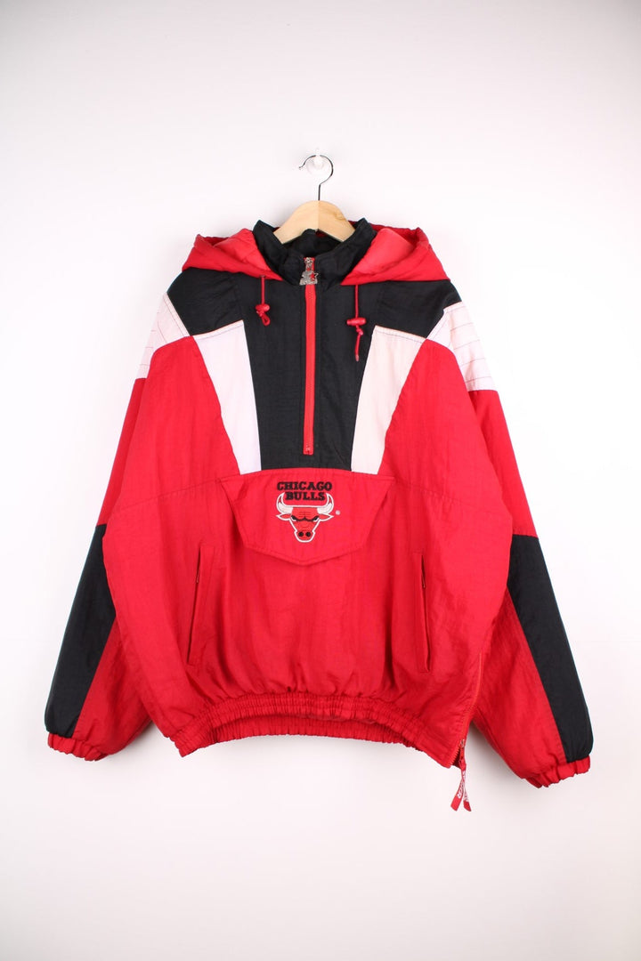 Chicago Bulls NBA pro sport jacket in a red colourway with white and black panels. Zip closure and hood with team logos embroidered on the front and back.