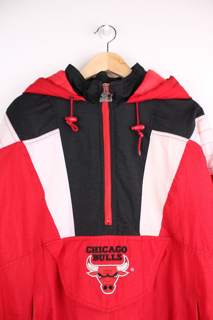 Chicago Bulls NBA pro sport jacket in a red colourway with white and black panels. Zip closure and hood with team logos embroidered on the front and back.