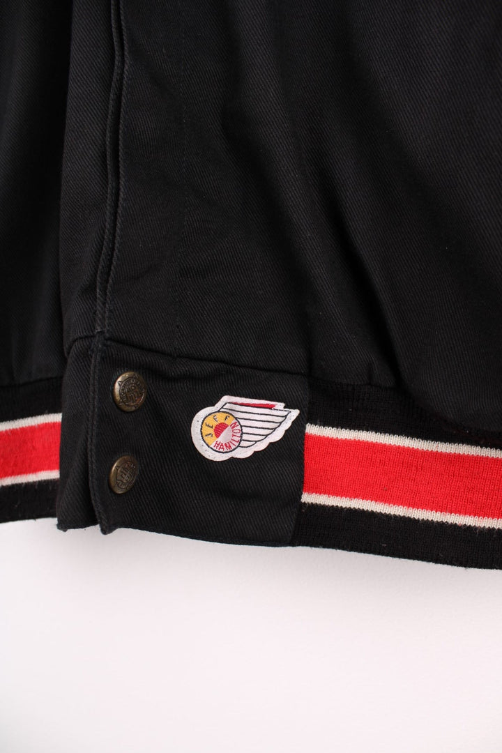 San Francisco 49s, NFL, Jeff Hamilton bomber-style pro sport jacket in a black colourway with white, red and tan detail. Zip closure with team logos embroidered on the front and back.