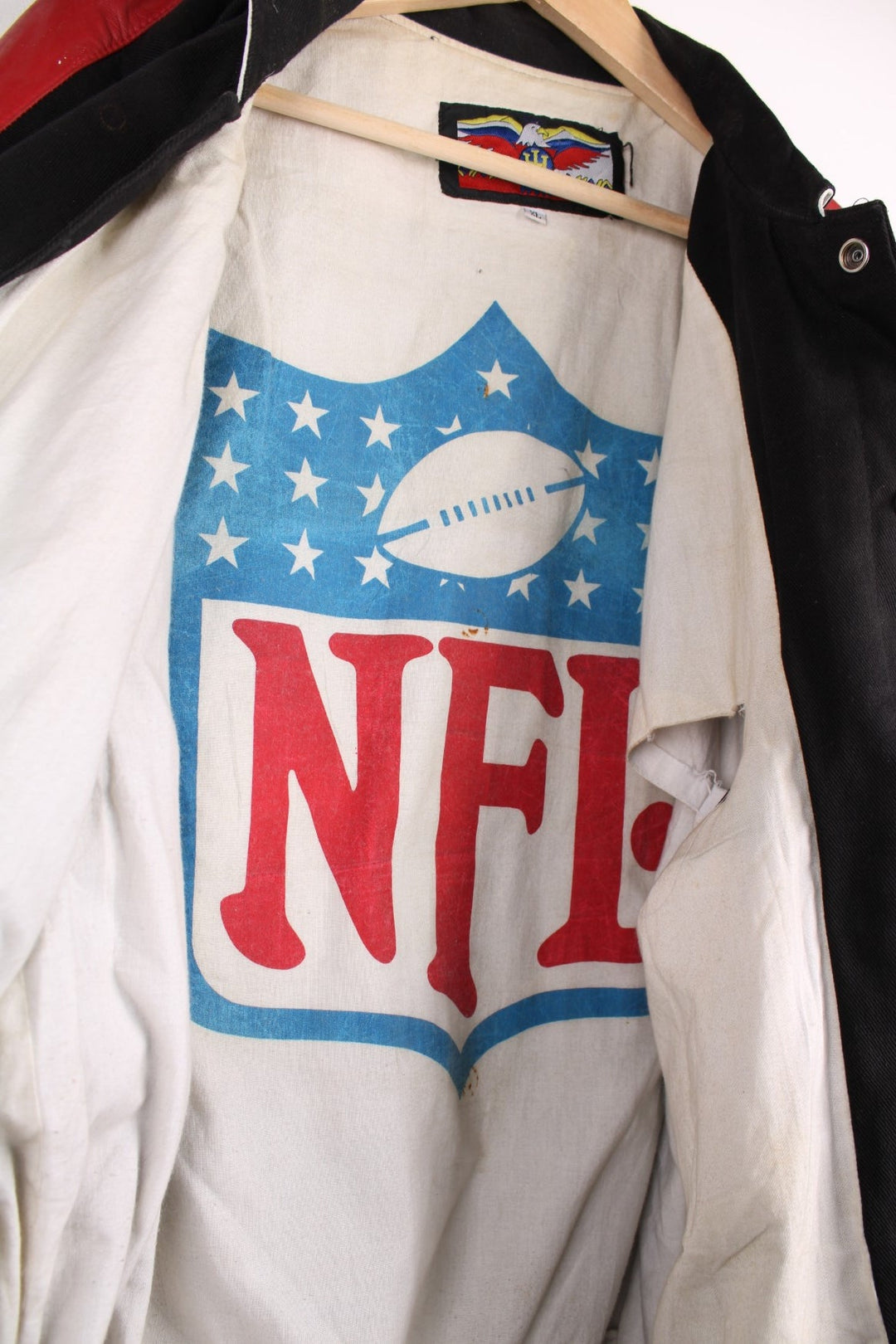 San Francisco 49s, NFL, Jeff Hamilton bomber-style pro sport jacket in a black colourway with white, red and tan detail. Zip closure with team logos embroidered on the front and back.