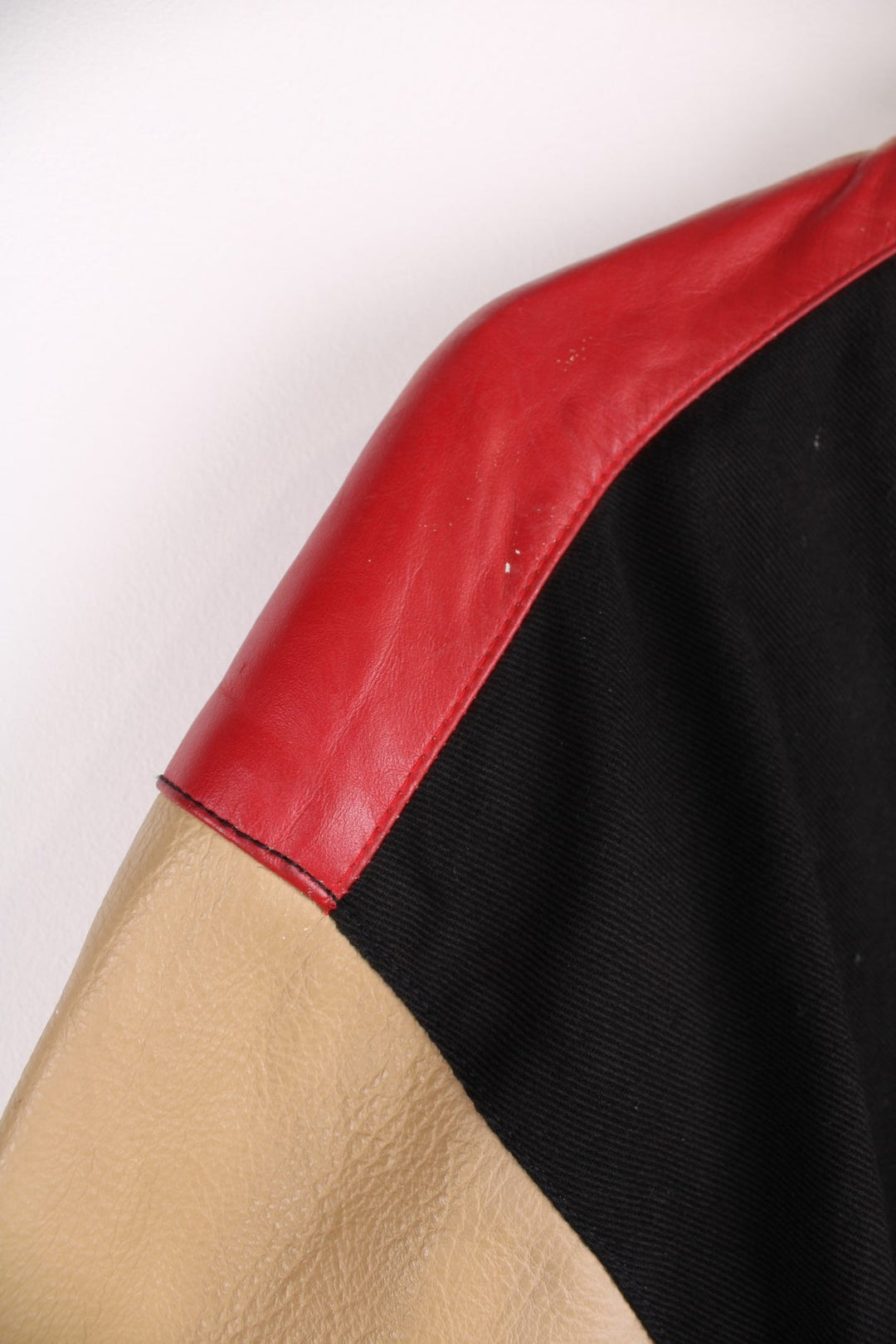 San Francisco 49s, NFL, Jeff Hamilton bomber-style pro sport jacket in a black colourway with white, red and tan detail. Zip closure with team logos embroidered on the front and back.