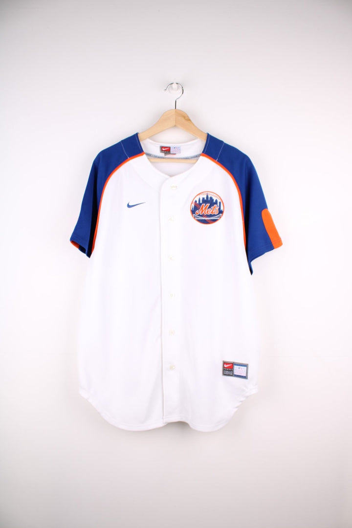 Nike New York Mets MLB jersey in white with blue sleeves and orange piping, Nike swoosh and team logo embrodiered on the front and Beltran no.15 on the back.