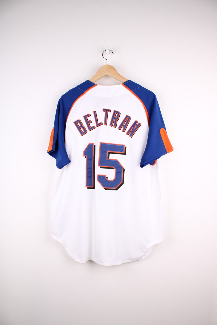 Nike New York Mets MLB jersey in white with blue sleeves and orange piping, Nike swoosh and team logo embrodiered on the front and Beltran no.15 on the back.