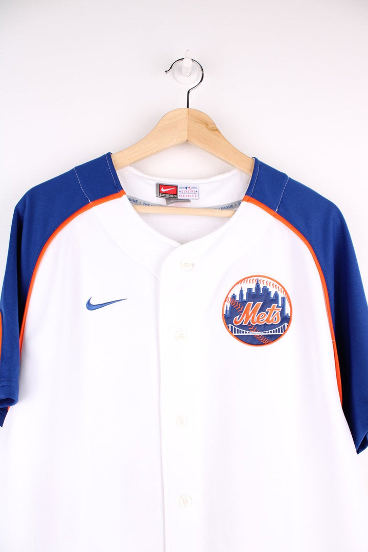 Nike New York Mets MLB jersey in white with blue sleeves and orange piping, Nike swoosh and team logo embrodiered on the front and Beltran no.15 on the back.