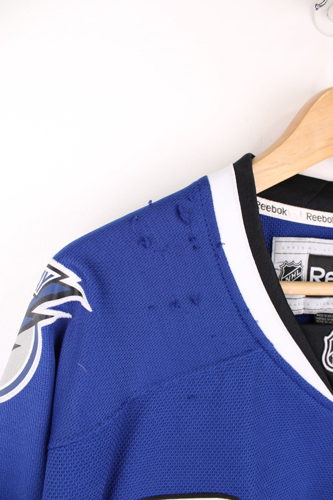 Tampa Bay Lightning Reebok, NHL Hockey Jersey. Features embroidered "BOLTS" across the front and badges on the sleeves. 