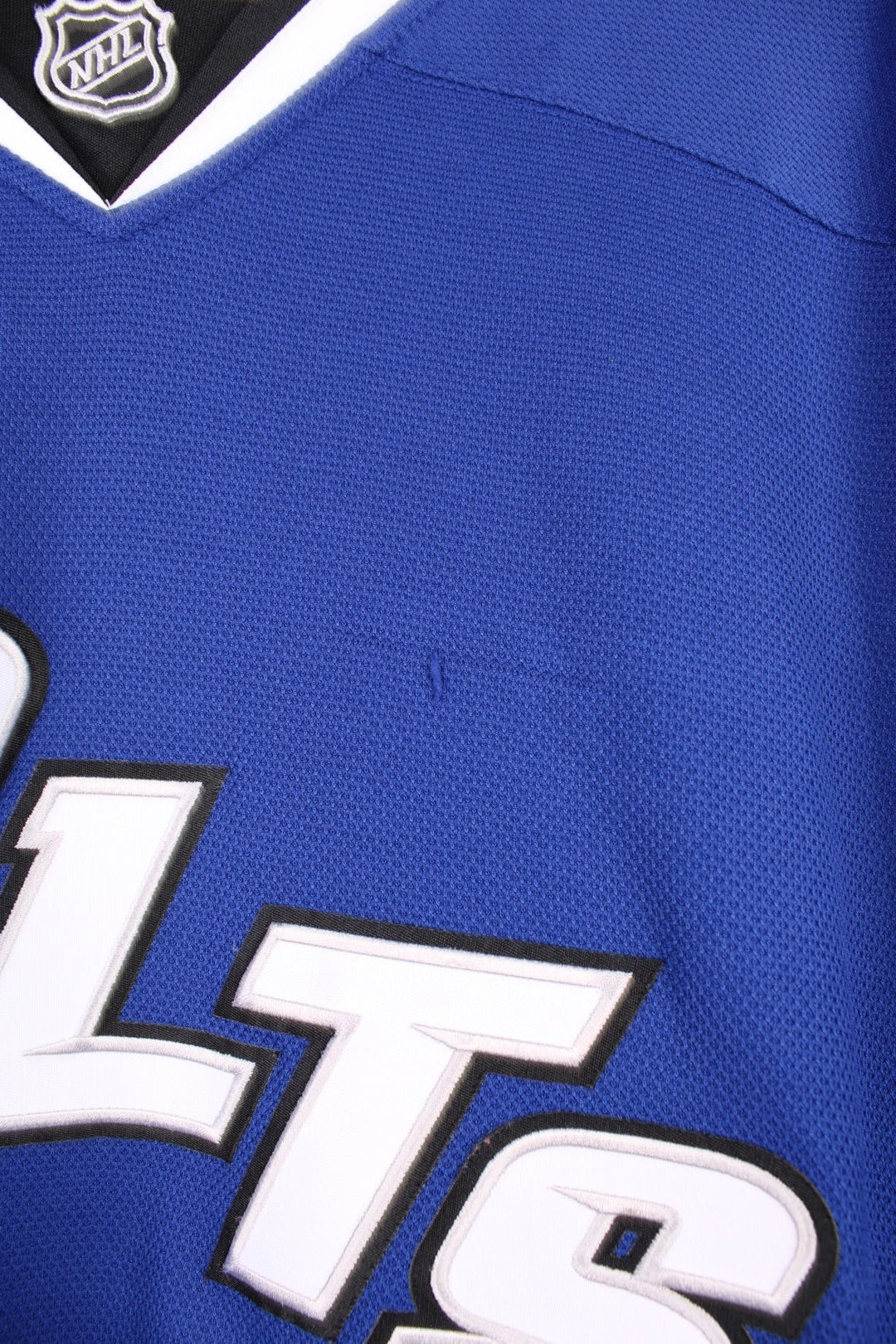 Tampa Bay Lightning Reebok, NHL Hockey Jersey. Features embroidered "BOLTS" across the front and badges on the sleeves. 