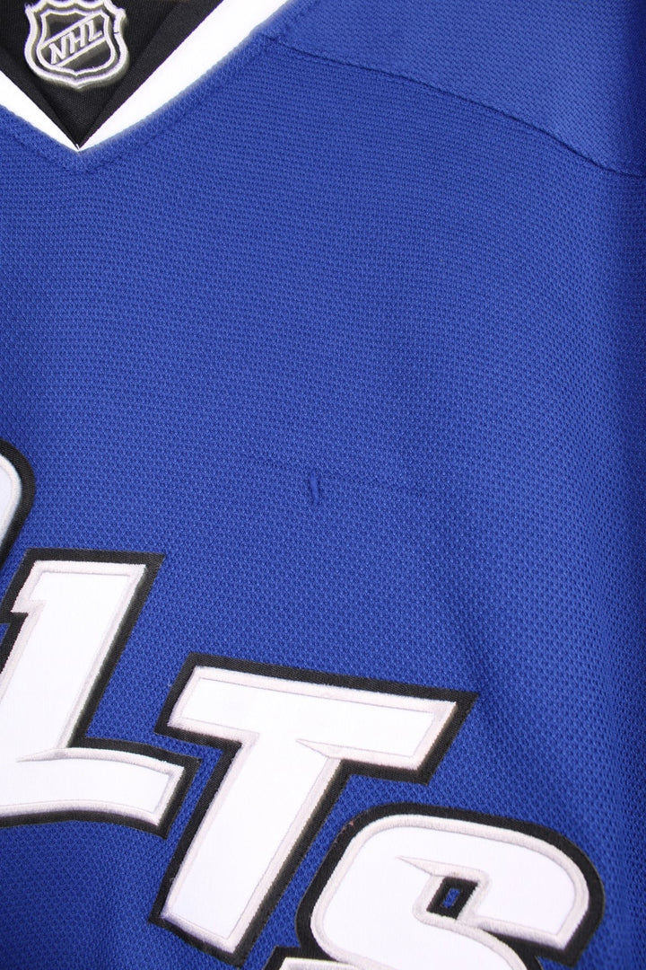 Tampa Bay Lightning Reebok, NHL Hockey Jersey. Features embroidered "BOLTS" across the front and badges on the sleeves. 