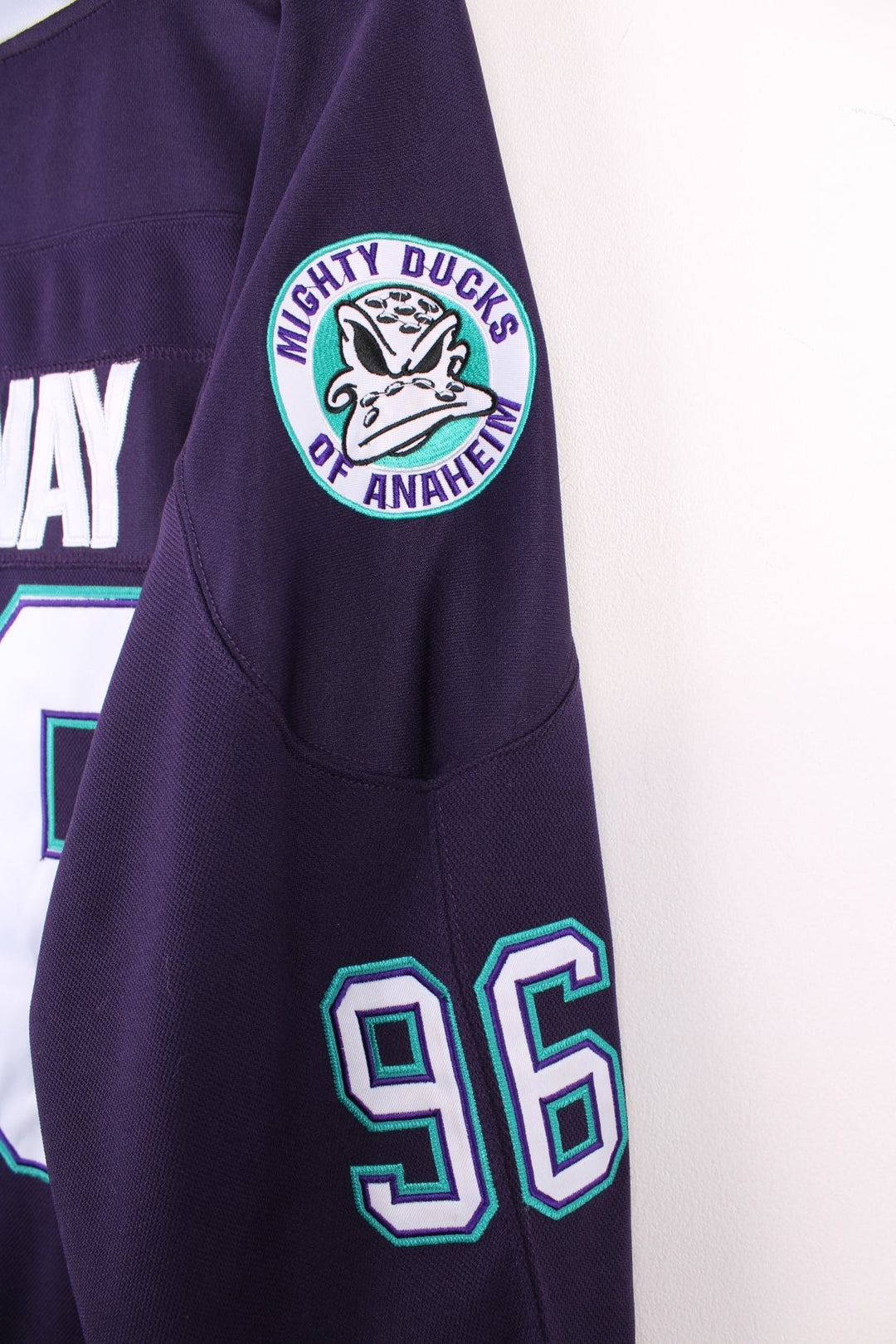 Anaheim Mighty Ducks NHL jersey in purple with blue and white stripe accents, features embroidered logos and no.96 Conway on the back.