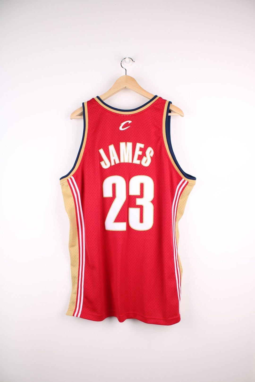 Cleveland Cavaliers NBA jersey in red with  yellow and navy accents, multiple embroidered logos, and no.23 James on the back.