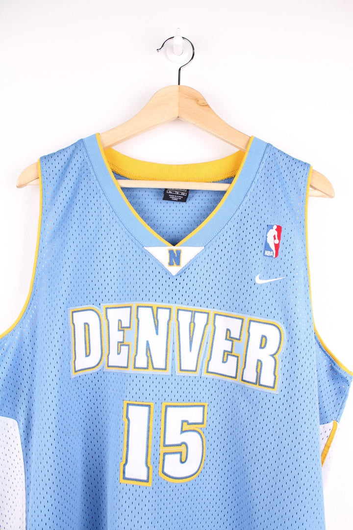 Denver Nuggets NBA in blue with yellow and white accents, multiple embroidered logos and no.15 Anthony on the back.