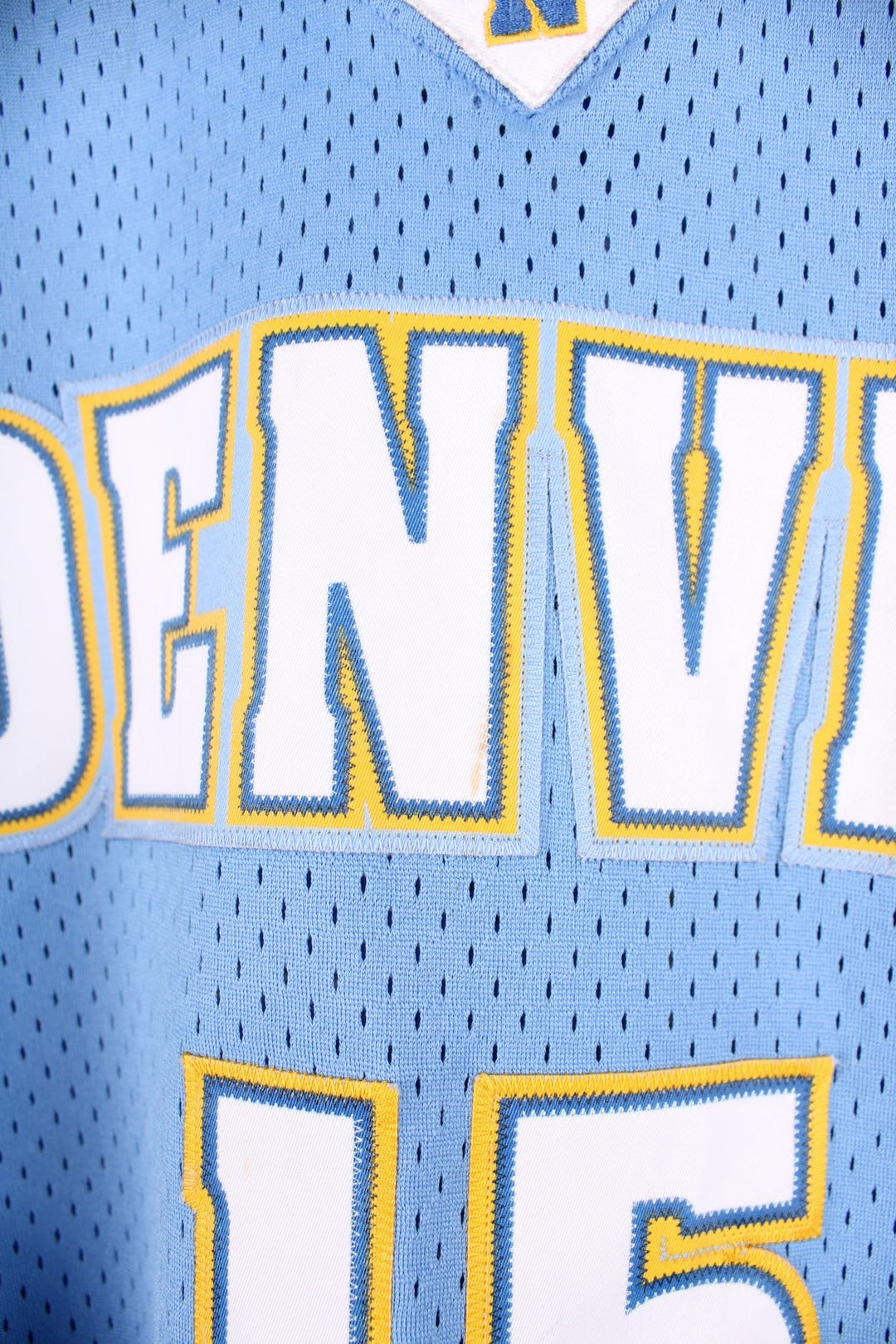 Denver Nuggets NBA in blue with yellow and white accents, multiple embroidered logos and no.15 Anthony on the back.