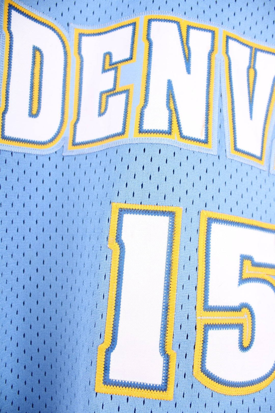 Denver Nuggets NBA in blue with yellow and white accents, multiple embroidered logos and no.15 Anthony on the back.