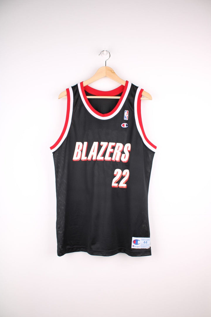 Portland Trail Blazers NBA jersey in black with red and white accents, multiple embroidered logos, and no.22 Drexler on the back.