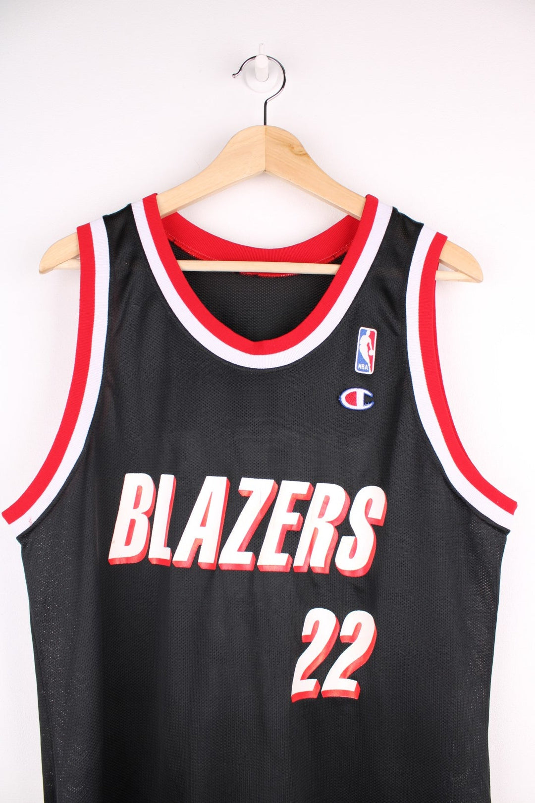 Portland Trail Blazers NBA jersey in black with red and white accents, multiple embroidered logos, and no.22 Drexler on the back.