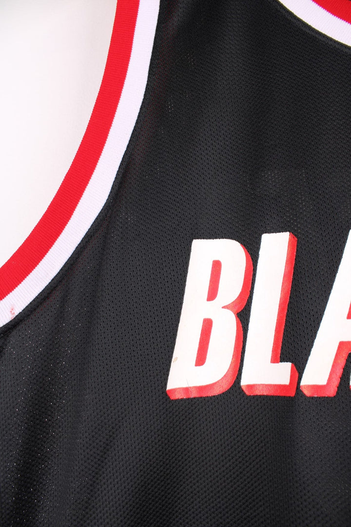 Portland Trail Blazers NBA jersey in black with red and white accents, multiple embroidered logos, and no.22 Drexler on the back.