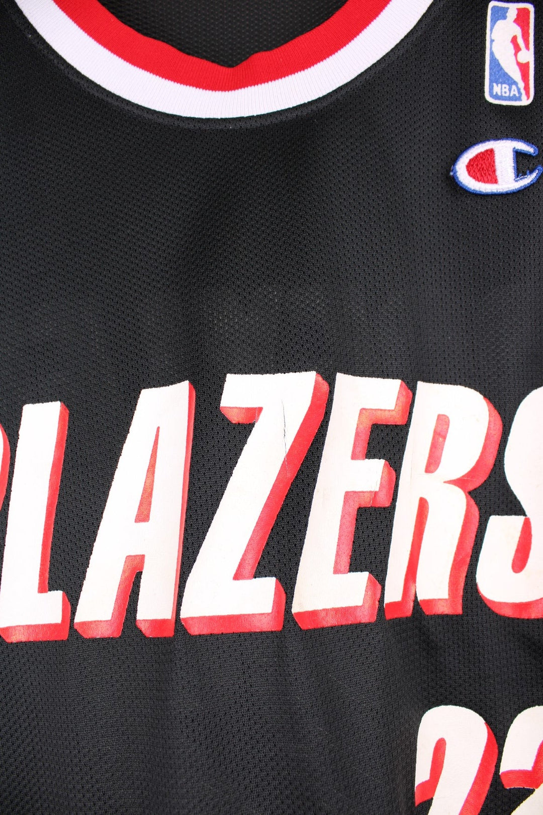 Portland Trail Blazers NBA jersey in black with red and white accents, multiple embroidered logos, and no.22 Drexler on the back.