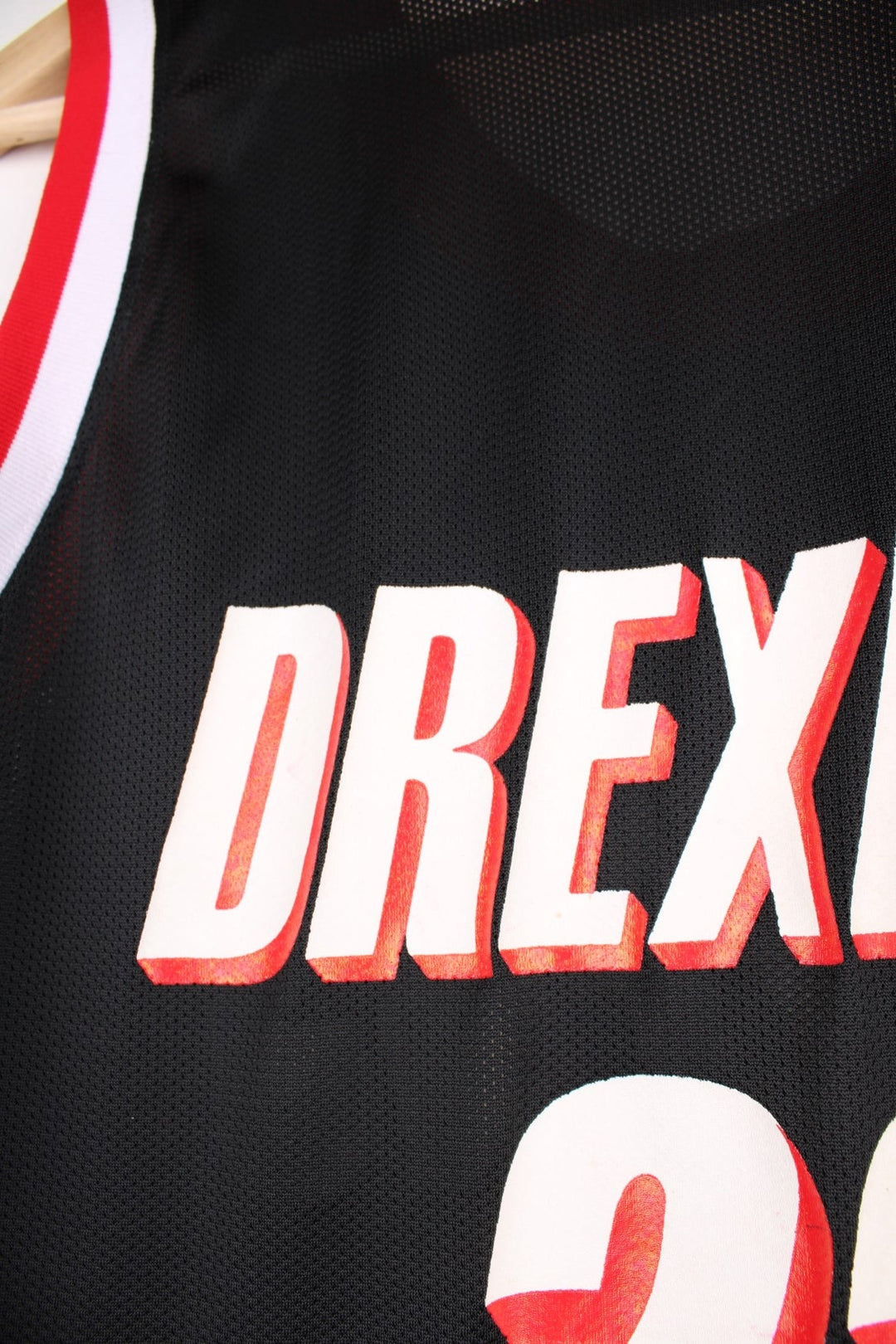 Portland Trail Blazers NBA jersey in black with red and white accents, multiple embroidered logos, and no.22 Drexler on the back.