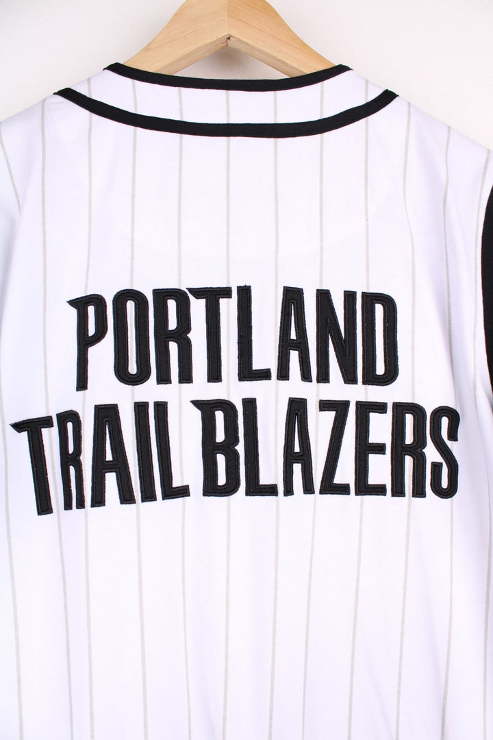 Portland Trail Blazers NBA button-up jersey in white with grey stripes and black and red accents, embroidered logos on the front and sleeve and team spellout on the back.