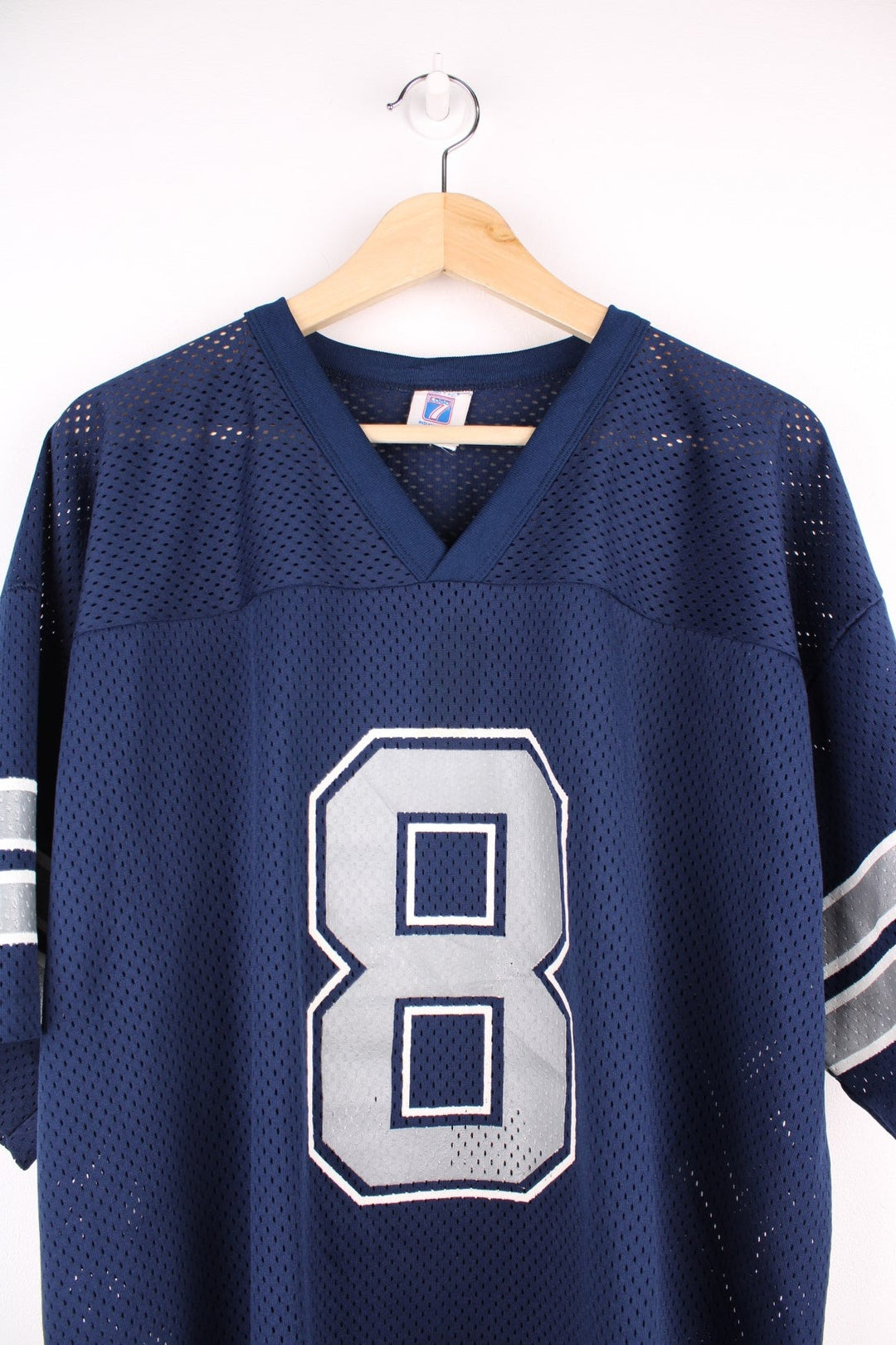 Dallas Cowboys Troy Aikman NFL jersey in blue with white and grey accents, an embroidered Logo 7 patch on the lower left side, and a number 8 printed on the front and back.