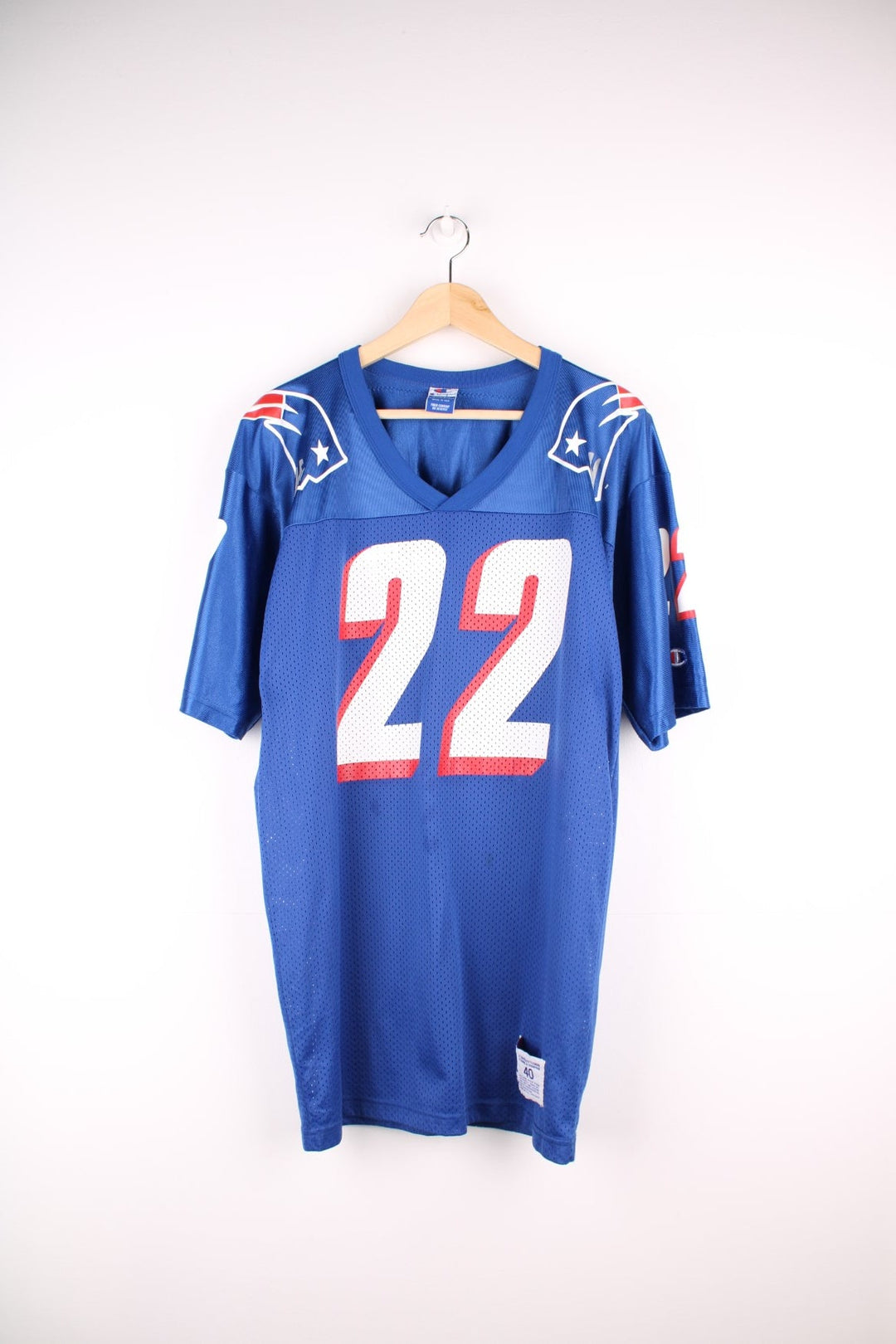 Champion New England Patriots jersey in blue with red and white accents, embroidered champion logos, printed team logos, and no. 22 Meggett on the back.