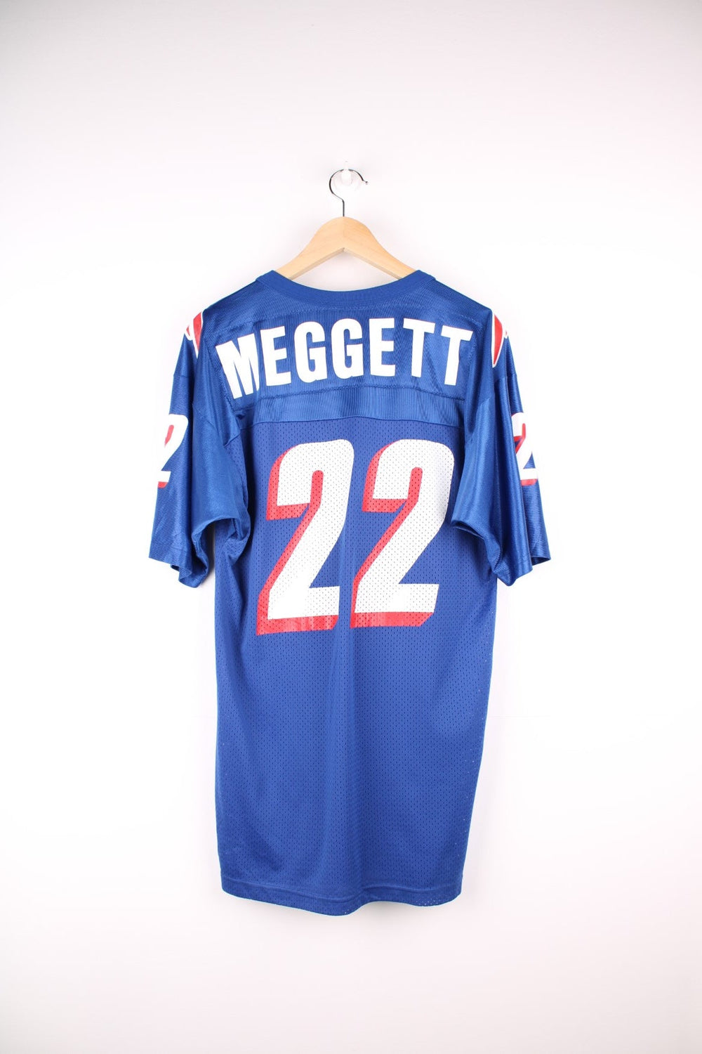 Champion New England Patriots jersey in blue with red and white accents, embroidered champion logos, printed team logos, and no. 22 Meggett on the back.