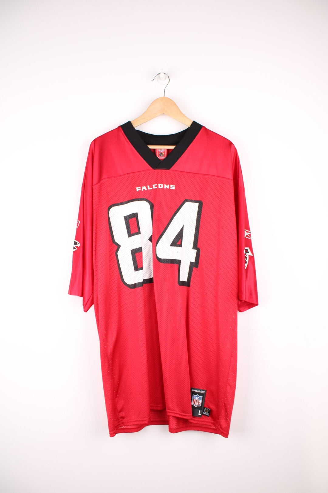 Atlanta Falcons, White #84, Reebok NFL Jersey. Features printed Falcons 84 on the front, and printed logos on both sleeves.