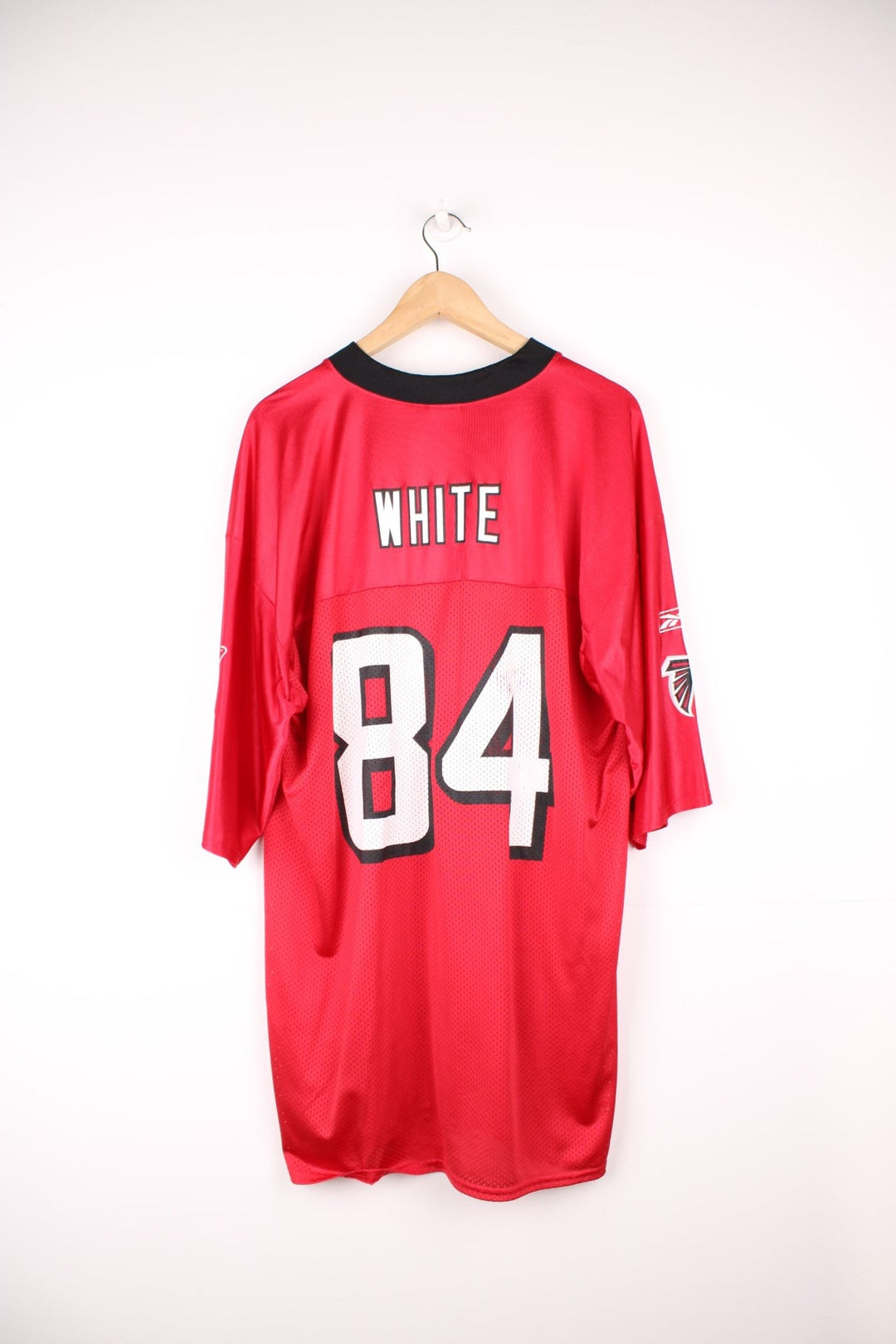 Atlanta Falcons, White #84, Reebok NFL Jersey. Features printed Falcons 84 on the front, and printed logos on both sleeves.