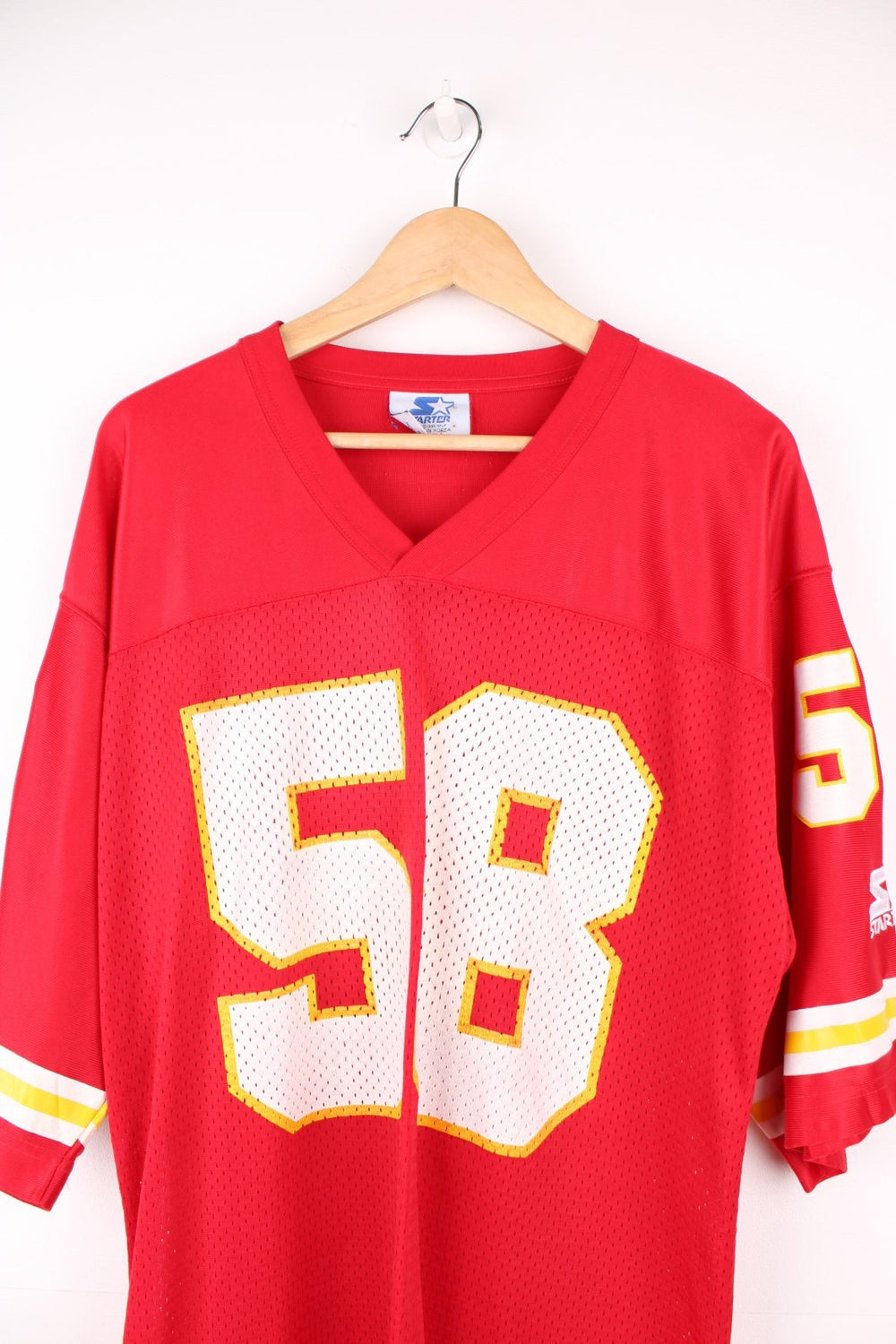 Kansas City Chiefs 58 Starter jersey in a red, white and yellow colourway. Features printed 58 on the front, back and sleeves, and embroidered starter logos.