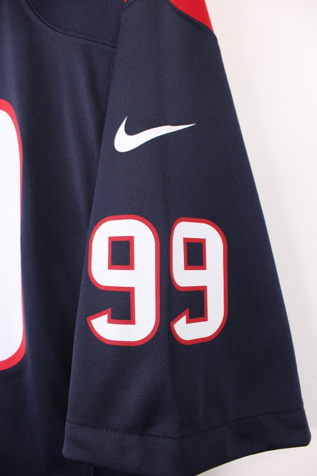 Houston Texans, Watt #99, Nike NFL jersey in a blue, red and white colourway. Features printed 99 on the front and back.