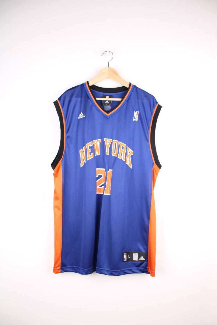 Adidas New York Knicks NBA jersey in blue with black and orange accents, multiple embroidered logos, and printed no.21 Chandler on the front and back.