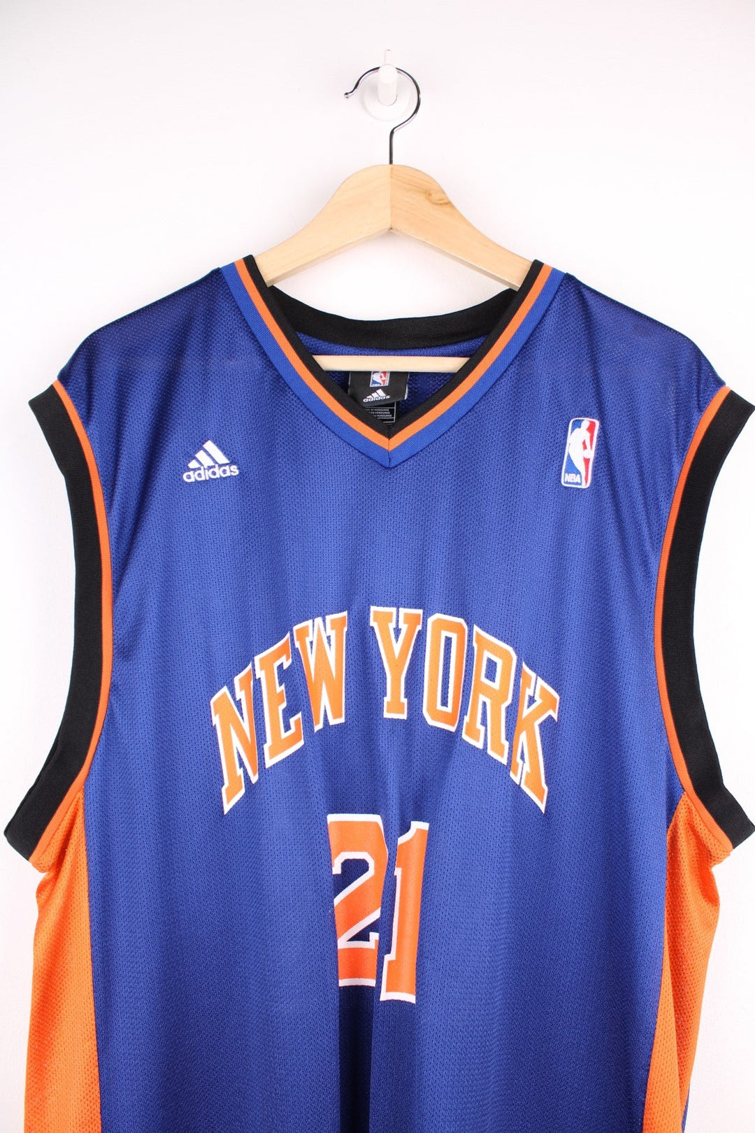 Adidas New York Knicks NBA jersey in blue with black and orange accents, multiple embroidered logos, and printed no.21 Chandler on the front and back.