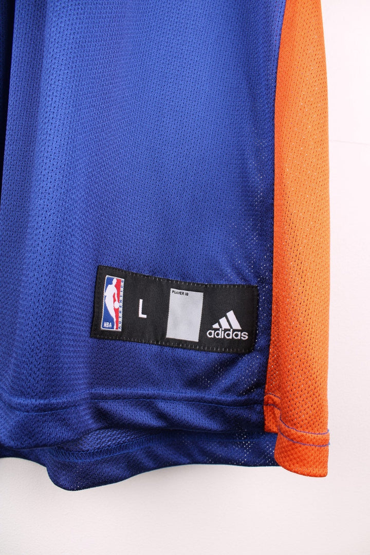 Adidas New York Knicks NBA jersey in blue with black and orange accents, multiple embroidered logos, and printed no.21 Chandler on the front and back.