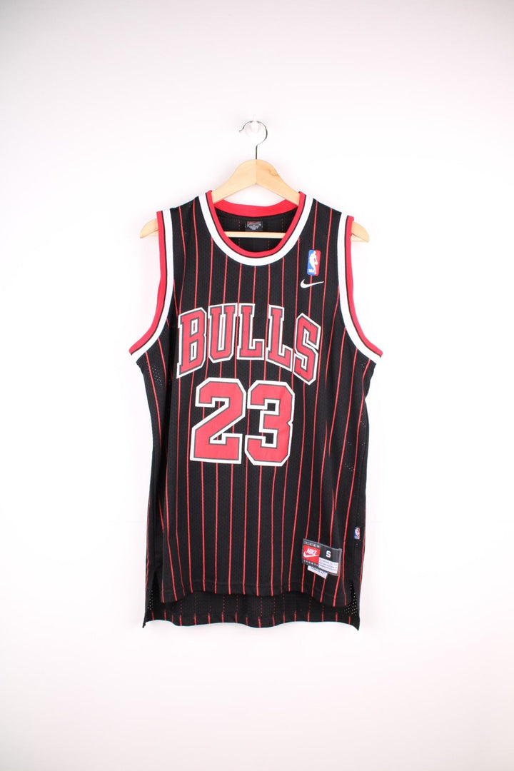 Chicago Bulls NBA jersey in black with red stripes, white accents, multiple embroidered logos, and no.23 Jordan on the front and back.