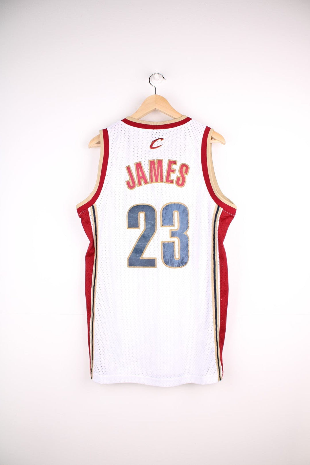 Cleveland Cavaliers NBA jersey in white with red and gold accents, multiple embroidered logos, no.23 Lebron James on the front and back.