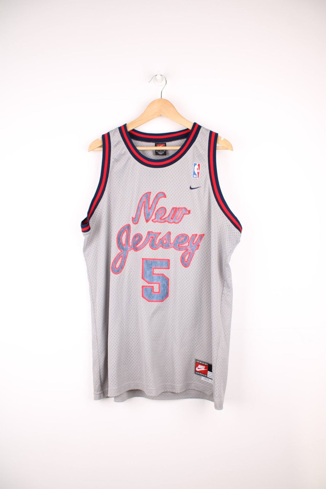 New Jersey Nets, Kidd #5 Nike NBA basketball jersey in a grey, red and blue colourway. Features embroidered lettering on the front and back, and logos on the chest.