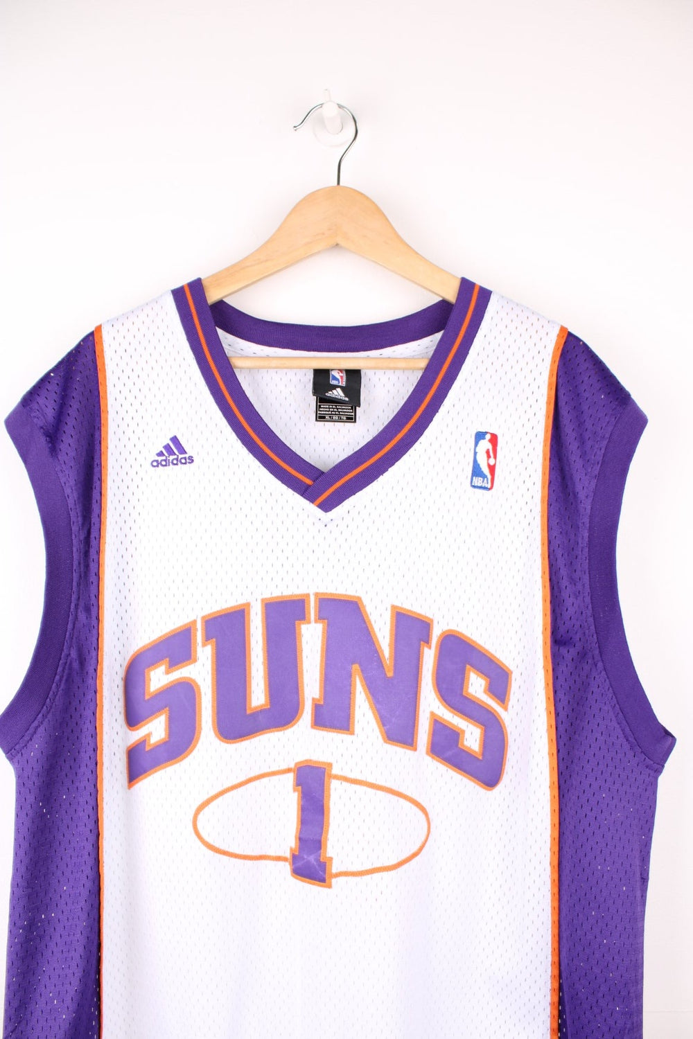 Phoenix Suns Amar'e Stoudemire #1 Adidas NBA jersey in a white, purple and orange colourway. Features embroidered lettering and logos on the chest.