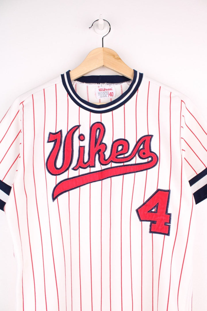 Wilson Vikes baseball jersey in white with red pinstripes, navy blue collar and cuffs, a red spellout, and no. 4 on the front and back..