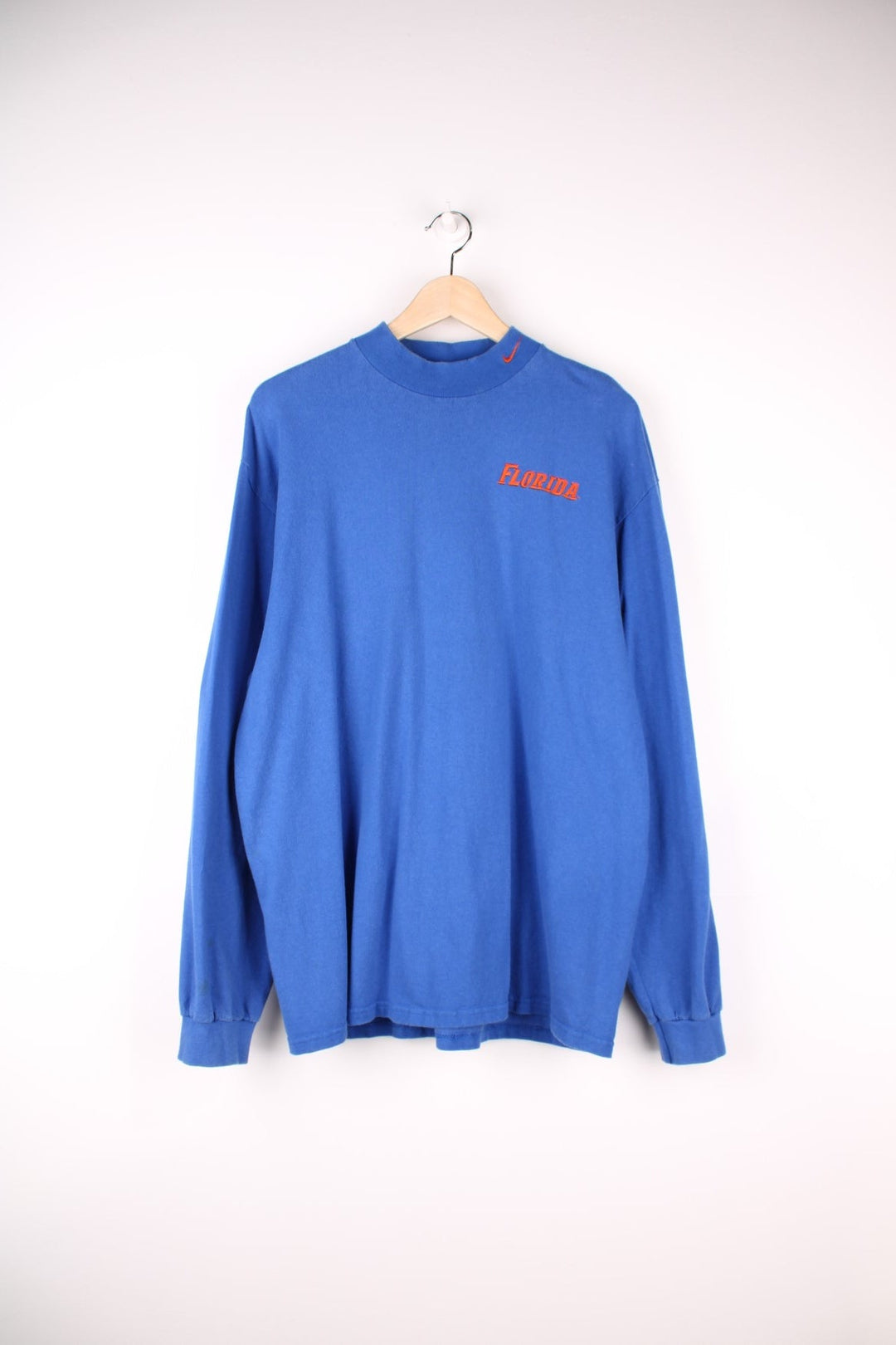 Florida Gators Nike Longsleeve T-Shirt in a blue colourway with the spell out and swoosh logo embroidered in orange on the front. 