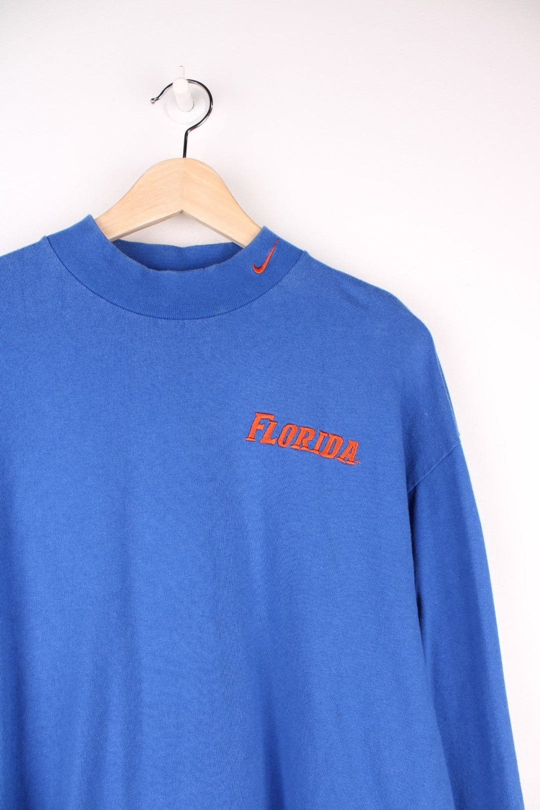 Florida Gators Nike Longsleeve T-Shirt in a blue colourway with the spell out and swoosh logo embroidered in orange on the front. 