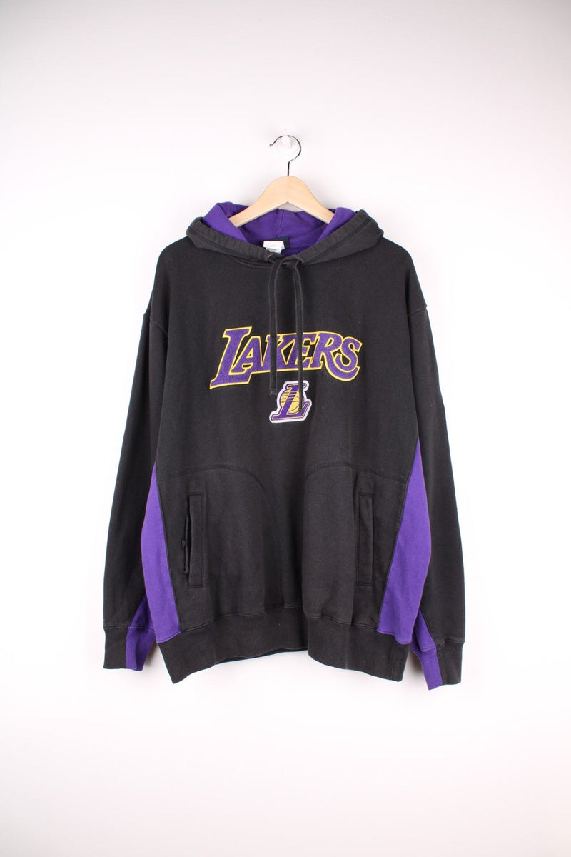 Los Angeles Lakers NBA Hoodie in a black and purple colourway with the spell out logo embroidered on the front. 