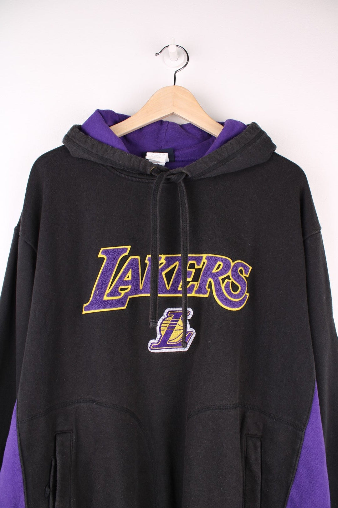 Los Angeles Lakers NBA Hoodie in a black and purple colourway with the spell out logo embroidered on the front. 