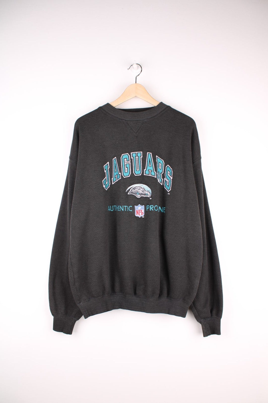 Vintage Jacksonville Jaguars Pro Line Sweatshirt in a faded black colourway with the spell out logo embroidered across the front. 