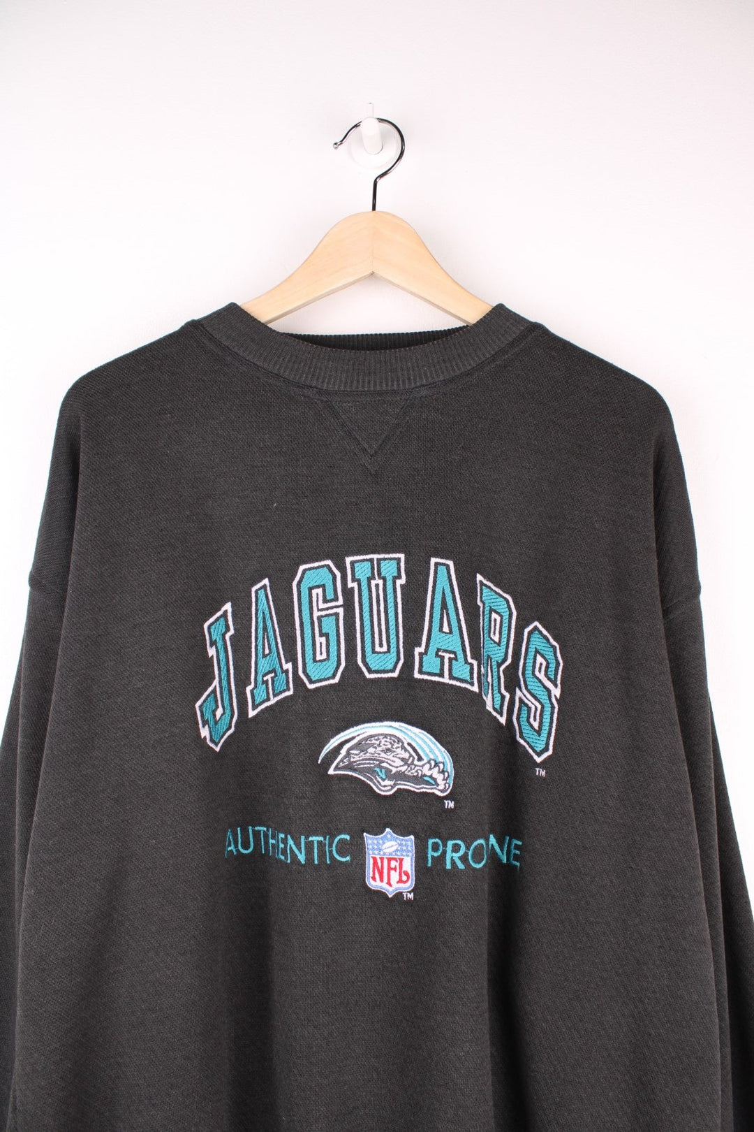 Vintage Jacksonville Jaguars Pro Line Sweatshirt in a faded black colourway with the spell out logo embroidered across the front. 