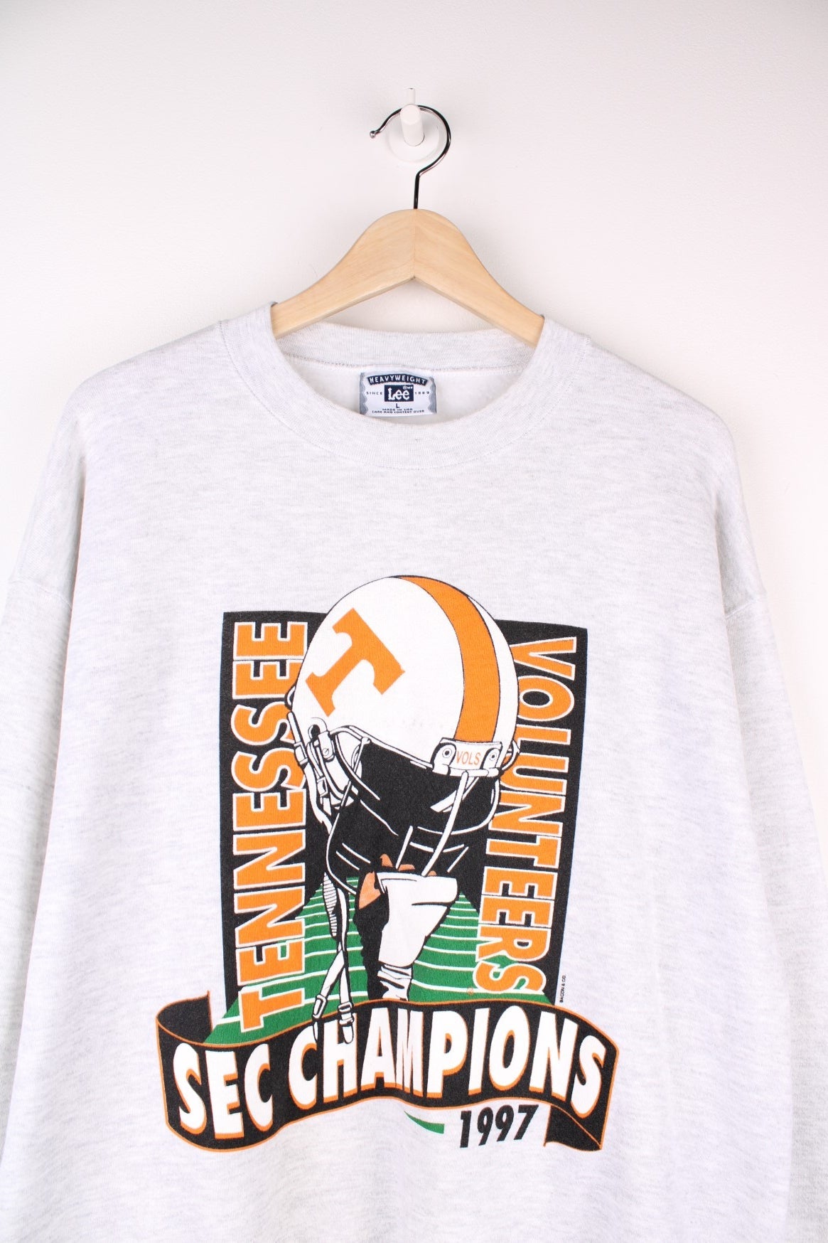 Vintage 1997 Tennessee Volunteers SEC Champions in a grey colourway with team spell out and football graphic printed on the front. 