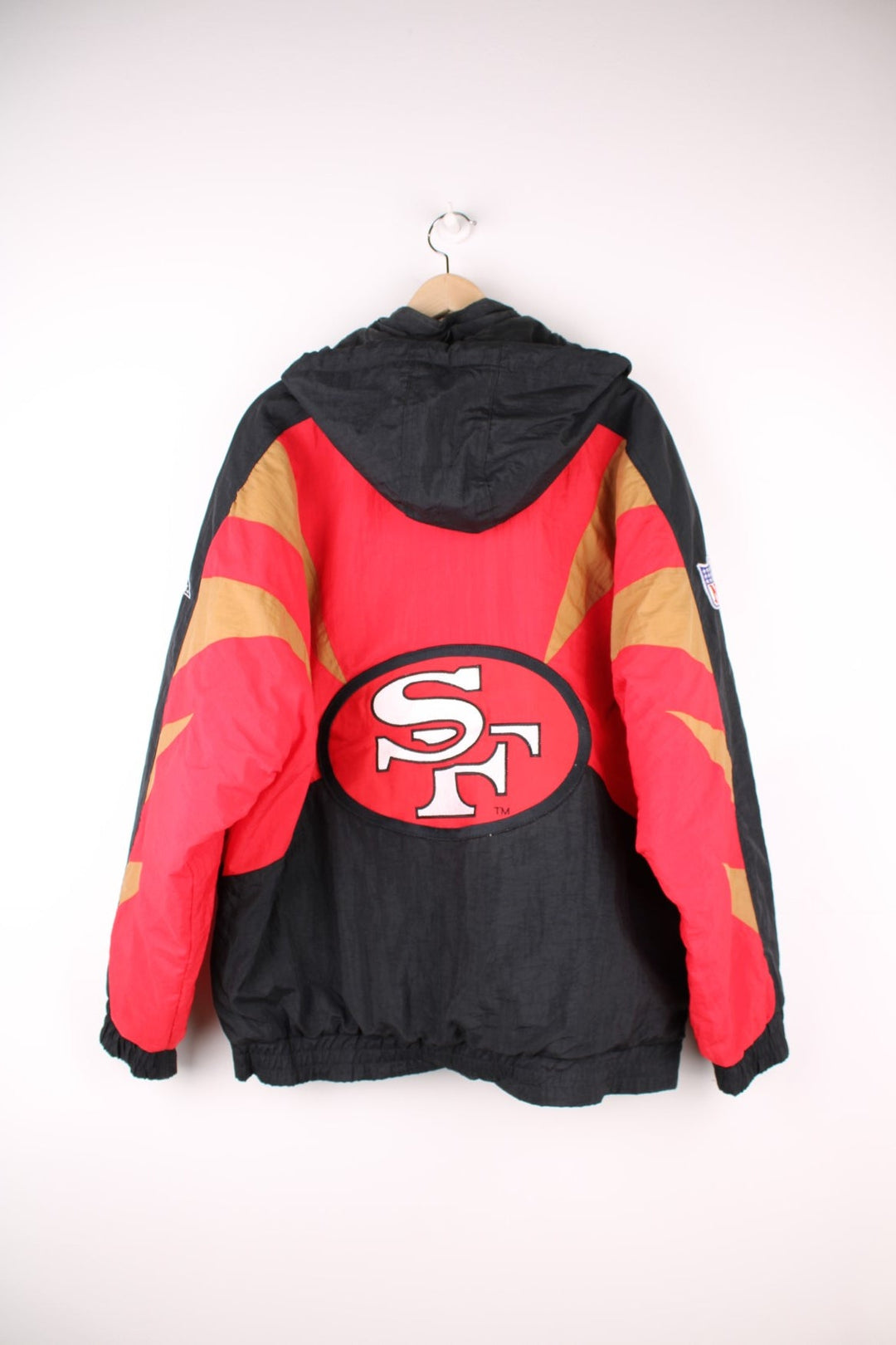 Vintage San Francisco 49ers Pro Line by Apex One Jacket in the red, black and gold team colourway, zip up with side pockets, has a detachable hood, quilted with a insulated lining, and has the logo embroidered on the front, sleeves, and back.