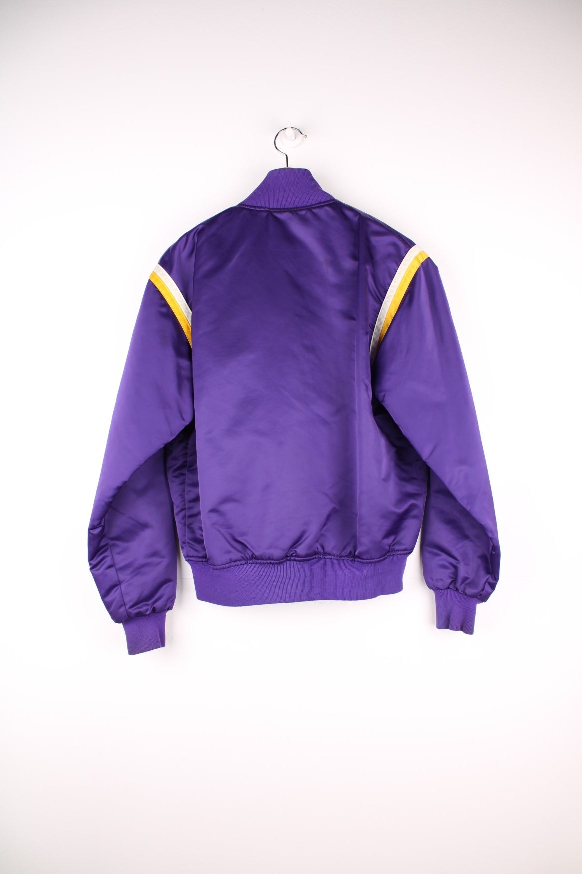 Los Angeles Lakers Starter NBA Varsity Jacket in a purple, yellow and white colourway, button up with side pockets, insulated with a quilted lining, and has the team and NBA logo embroidered on the front.