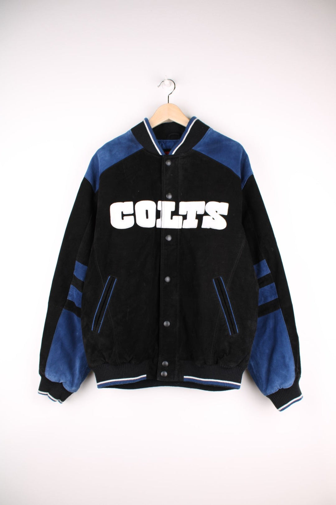 Indianapolis Colts Leather Varsity Jacket in a black and blue colourway, button up with side pockets, insulated with a quilted lining, and has the team spell out and logo embroidered on the front and back.