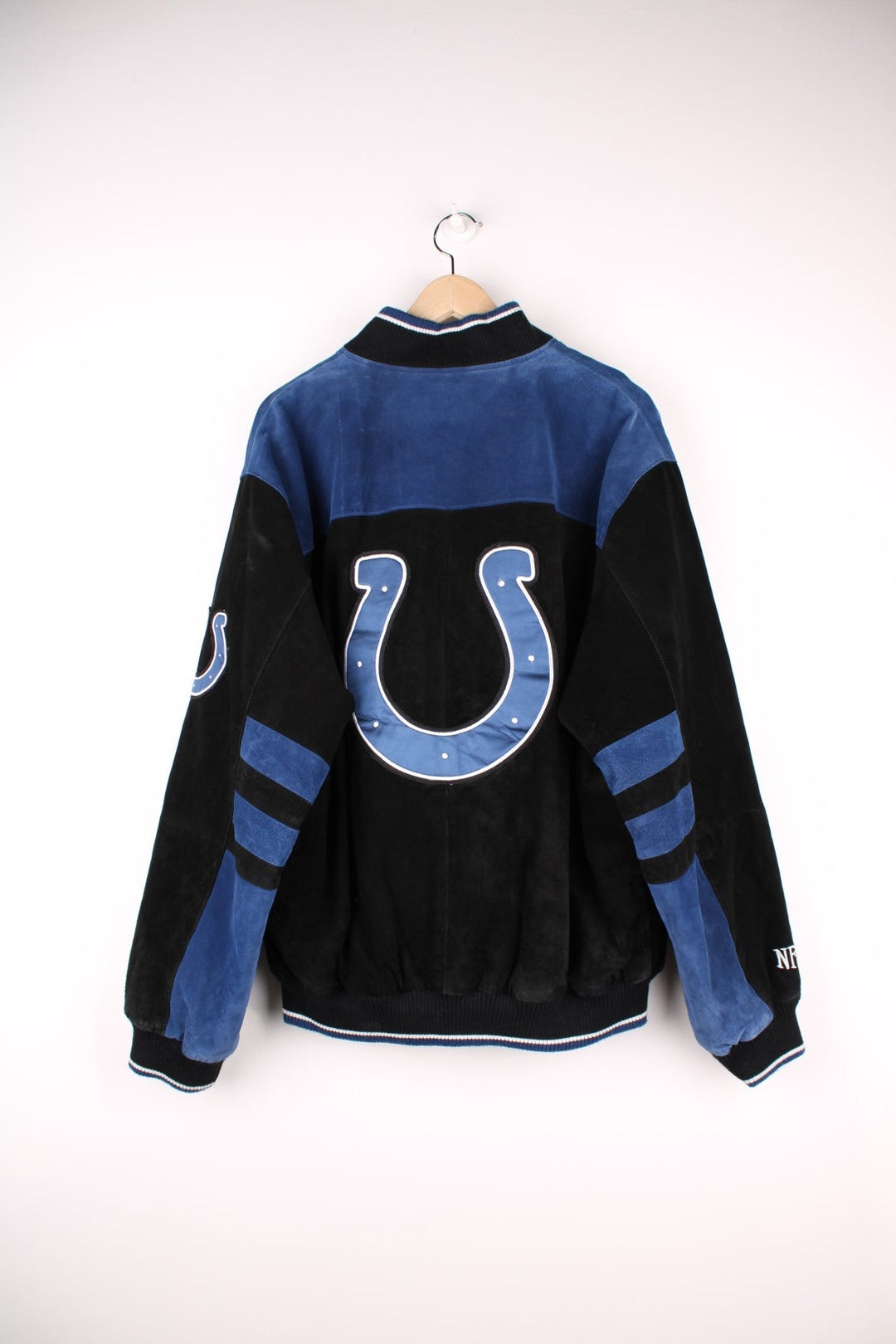 Indianapolis Colts Leather Varsity Jacket in a black and blue colourway, button up with side pockets, insulated with a quilted lining, and has the team spell out and logo embroidered on the front and back.