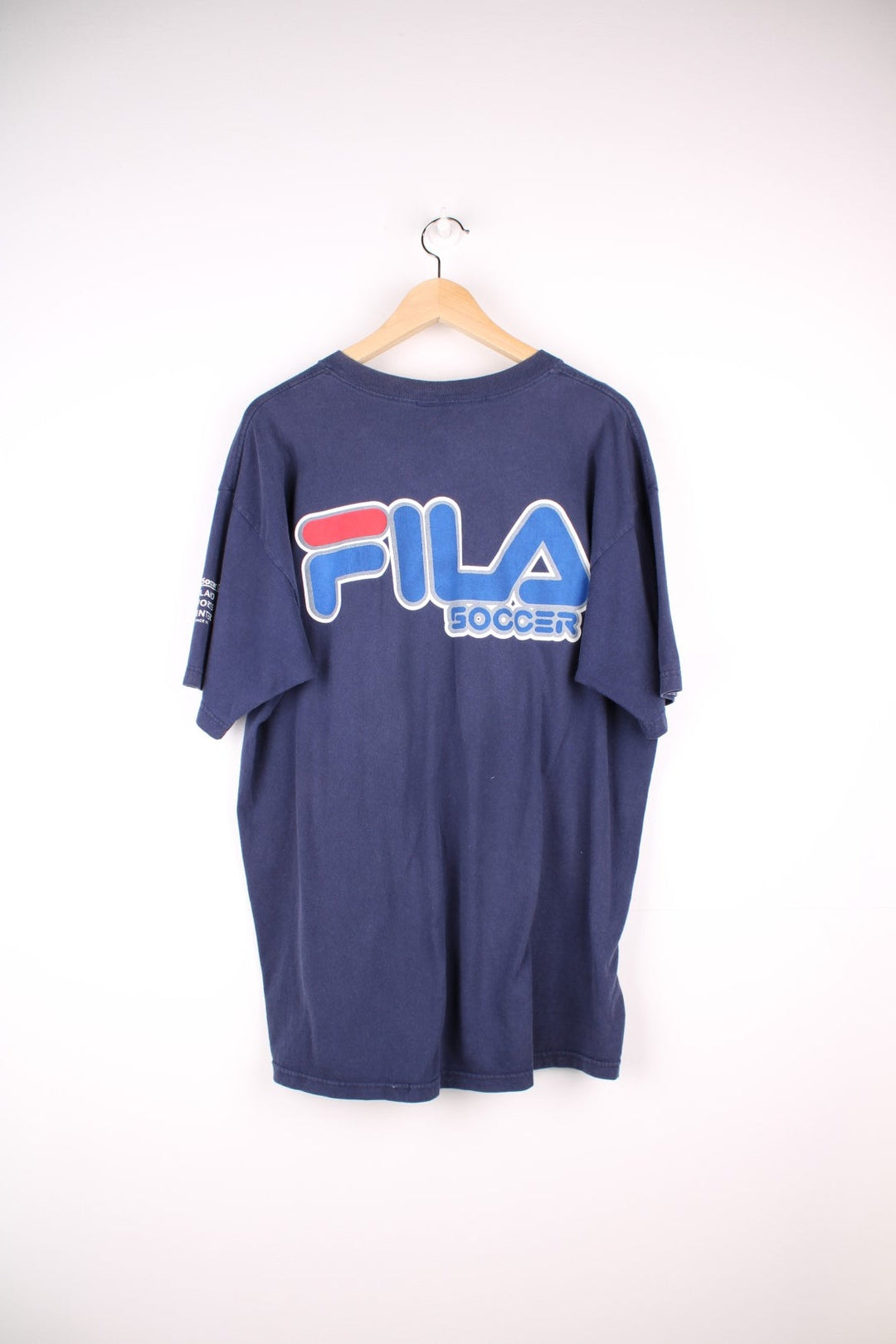 Fila FC Dallas soccer t-shirt in navy blue with front star logo graphic, spellout reading 'Dallas Cup XIX', and Fila Sport logos on the front, back and sleeve.